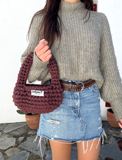 Trendy round crochet handbag, made from 100% recycled cotton, adding a unique touch to any outfit.