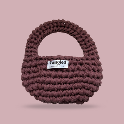 Trendy round crochet handbag, made from 100% recycled cotton, adding a unique touch to any outfit.